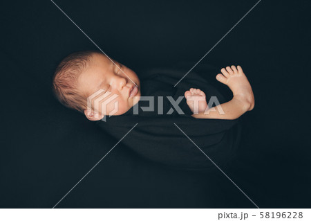 the concept of healthy lifestyle, IVF - a newborn baby sleeps under a blanket. Head, legs and arms 58196228