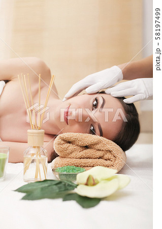Young pretty woman enjoying face massage procedure 58197499