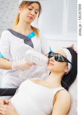Body Care. Underarm Laser Hair Removal. Beautician Removing Hair Of Young Woman's Armpit. Laser Body Care. Underarm Laser Hair Removal. Beautician Removing Hair Of Young Woman's Armpit. Laser 58197899