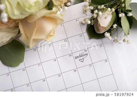 Choosing wedding date with pen writing heart on paper calendar 58197924