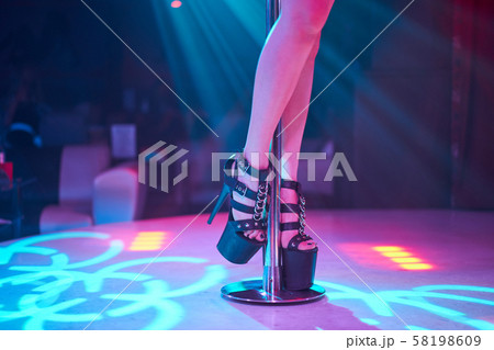 Young sexy woman pole dancing striptease with pylon in night club. Beautiful naked stripper girl on 58198609