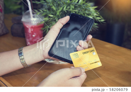 Woman shopping on the internet with smartphone and 58206079