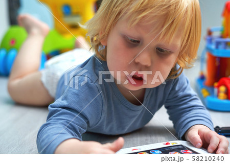 A child of three years old plays with a training A child of three years old plays with a training 58210240