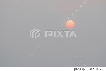 Sunrise sky covered with haze , making it look unusual Sunrise sky covered with haze , making it look unusual 58210375