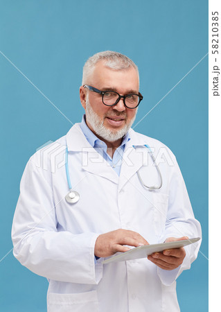 Skilled doctor with digital tablet Skilled doctor with digital tablet 58210385