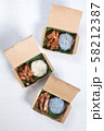 Sticky rice with grilled pork and fried pork put in a brown paper 58212387