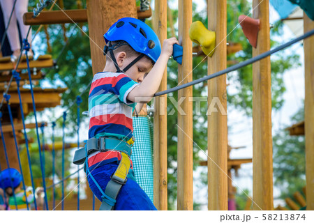 happy boy on the zip line. proud of his courage 58213874