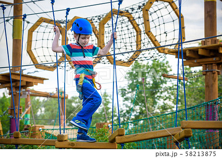 happy boy on the zip line. proud of his courage 58213875
