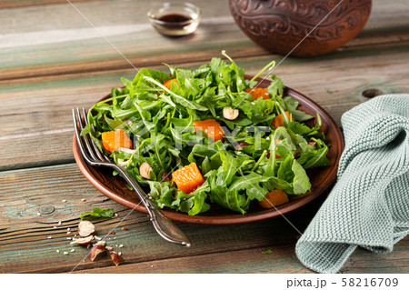 Delicious salad with arugula and baked pumpkin 58216709