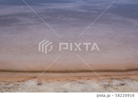 Natural white salt crystal texture on the sand, macro, close up. Salty lake shore background. Natural white salt crystal texture on the sand, macro, close up. Salty lake shore background. 58220916