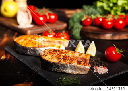 Grilled salmon rings placed on a stone platter 58221536