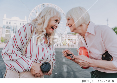 Two laughing older women are staying on square 58224010
