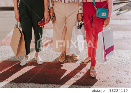 Fashionable grandmothers are standing in classic trousers Fashionable grandmothers are standing in classic trousers 58224119