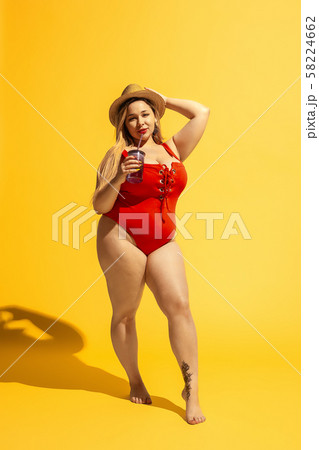 Young caucasian plus size female model's preparing for beach resort 58224662