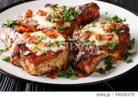Cooked juicy pork chops with parmesan and bacon Cooked juicy pork chops with parmesan and bacon 58226170