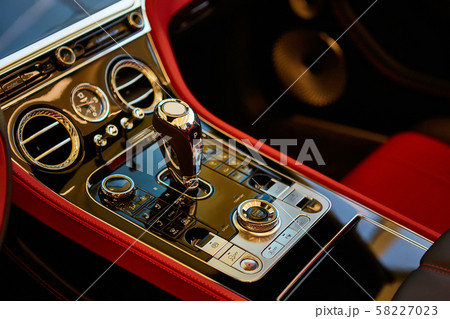 Automatic gear shift handle. Red luxury car Interior. Shallow doff. Automatic gear shift handle. Red luxury car Interior. Shallow doff. 58227023