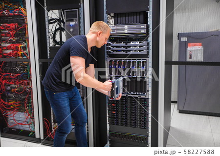 Computer Engineer Installing Server Into Blade Enclosure 58227588