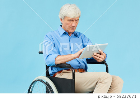 Disabled patient using tablet pc 58227671