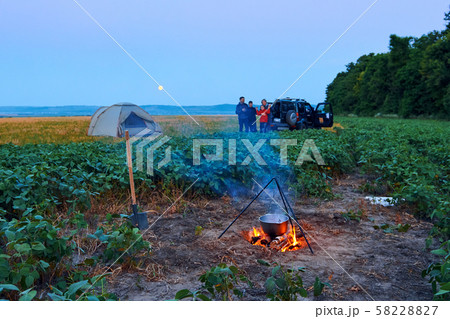 Family traveling and camping, twilight, cooking on 58228827