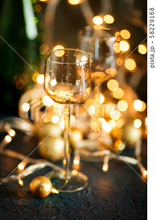 Glasses for wine and golden Christmas balls 58229168