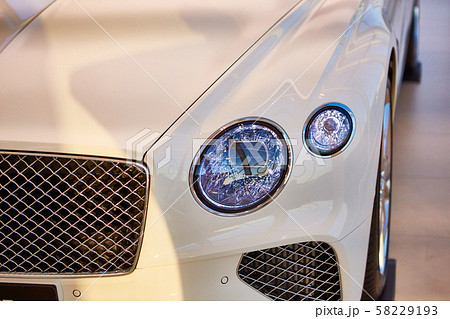 Headlight detail of luxury car. Closeup of sedan headlamp. Car headlight background 58229193