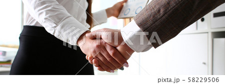 Man in suit and tie give hand as hello in office Man in suit and tie give hand as hello in office 58229506