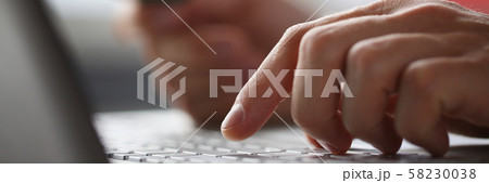 Male arms hold credit card press buttons making Male arms hold credit card press buttons making 58230038