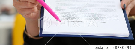 Female arm offer contract form on clipboard pad Female arm offer contract form on clipboard pad 58230294