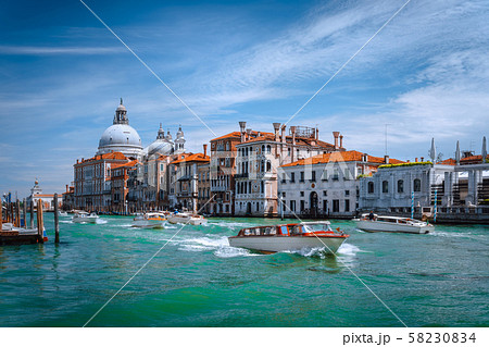 Pleasure tourist boats on Grand Canal and Basilica Santa Maria della Salute, Venice, Italy 58230834