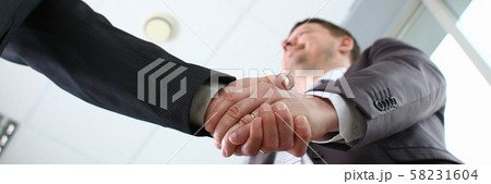 Man in suit shake hand as hello in office 58231604