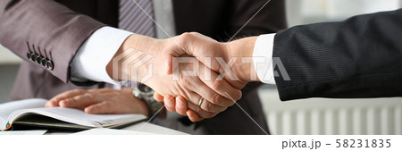Man in suit shake hand as hello in office Man in suit shake hand as hello in office 58231835