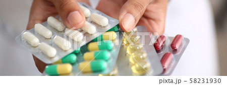 Female doctor hand holding pack of different 58231930