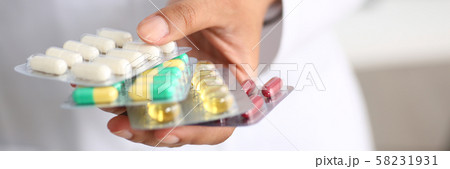 Female doctor hand holding pack of different Female doctor hand holding pack of different 58231931