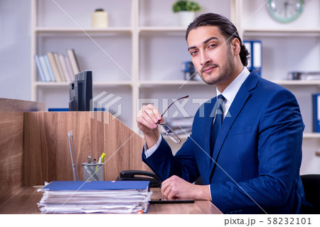 Young handsome businessman working in the office 58232101