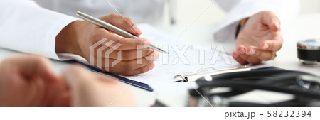 Female doctor hand hold silver pen filling Female doctor hand hold silver pen filling 58232394