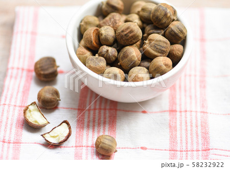 Chestnuts uncooked in bowl on the table genus Chestnuts uncooked in bowl on the table genus 58232922