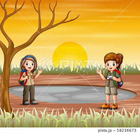 Two scout girls are exploring in dried land Two scout girls are exploring in dried land 58236673