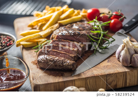 Beef Rib Eye steak with roasted potatoes bbq sauce 58239524