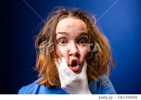 A hand makes a young girl speak. Girl with tousled hair under the pressure of surrounding people A hand makes a young girl speak. Girl with tousled hair under the pressure of surrounding people 58240066