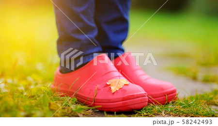 Close up photo of woman legs in rubber shoes 58242493
