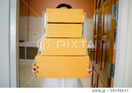 Technology delivery staff uniform handing a parcel box receiving parcel from delivery 58246637