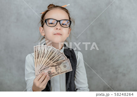 The lady's small business is on a gray background. Close-up During this, holds the money in hand. The lady's small business is on a gray background. Close-up During this, holds the money in hand. 58248264