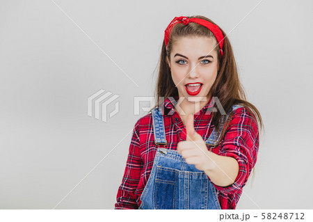 Pretty smiling girl joyfully pointing her fingers at the camera. Pretty smiling girl joyfully pointing her fingers at the camera. 58248712