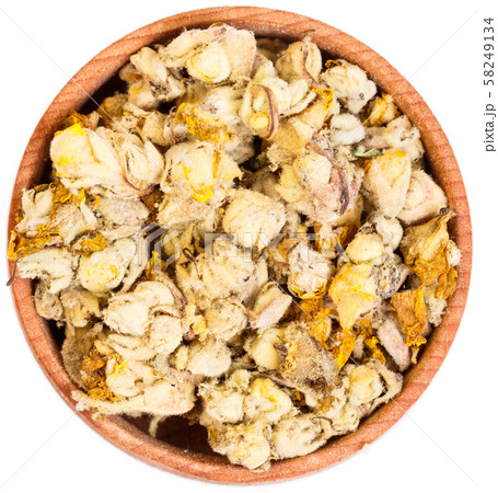 Orange mullein, Verbasci flos in a small wooden bow, isolated. 58249134