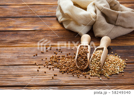 Green and fried buckwheat grains in the wooden scoops Green and fried buckwheat grains in the wooden scoops 58249340