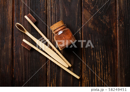 Close up of three bamboo toothbrushes and tooth powder Close up of three bamboo toothbrushes and tooth powder 58249451