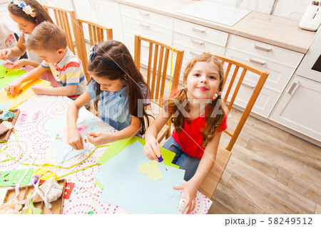 Little girl making postcard with her hands and smiling 58249512