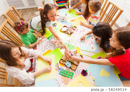 Little girls and boys on a craft lesson Little girls and boys on a craft lesson 58249514