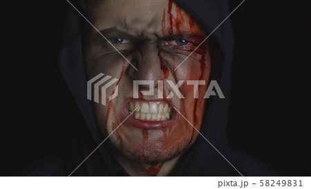Man executioner Halloween makeup and costume. Guy with blood on his face 58249831