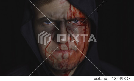Man executioner Halloween makeup and costume. Guy with blood on his face 58249833